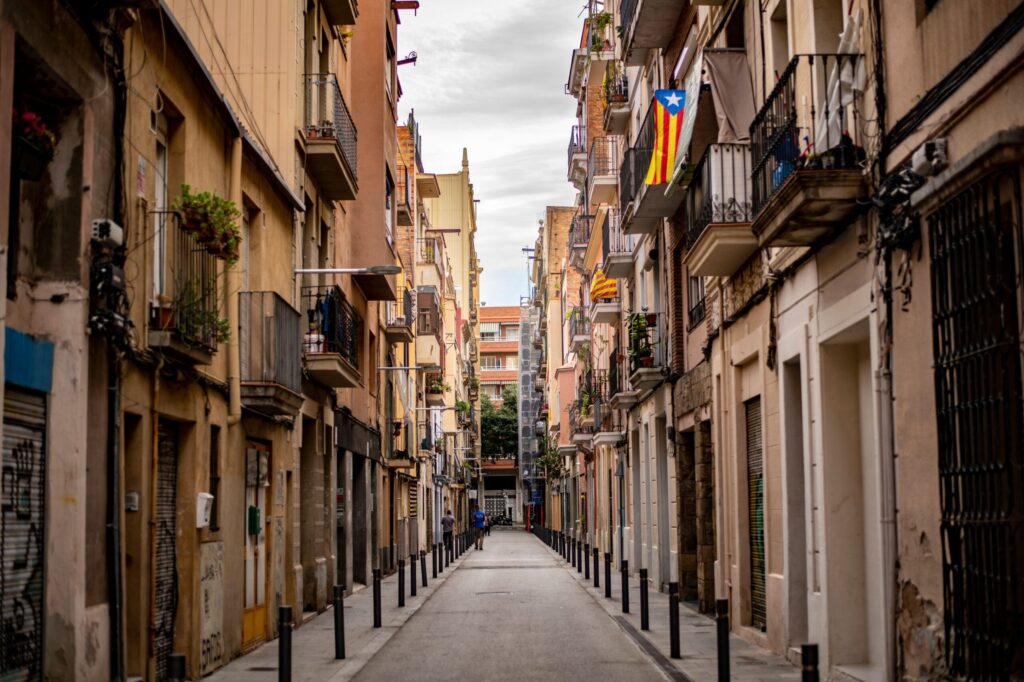 Quanto Custa Morar na Espanha em 2026? (A Conta Real) Vista urbana descontraída de uma rua espanhola, representando o estilo de vida mediterrâneo e a organização financeira para expatriados.